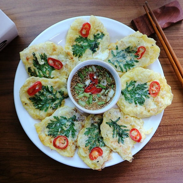 Korean style Pollock fish jeon (pancakes) with dipping sauce and garnishes