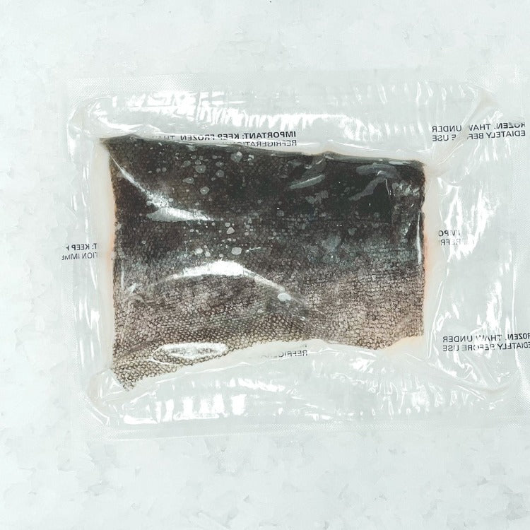 Frozen portion cut sablefish fillet with skin-on, vacuum-sealed for quality