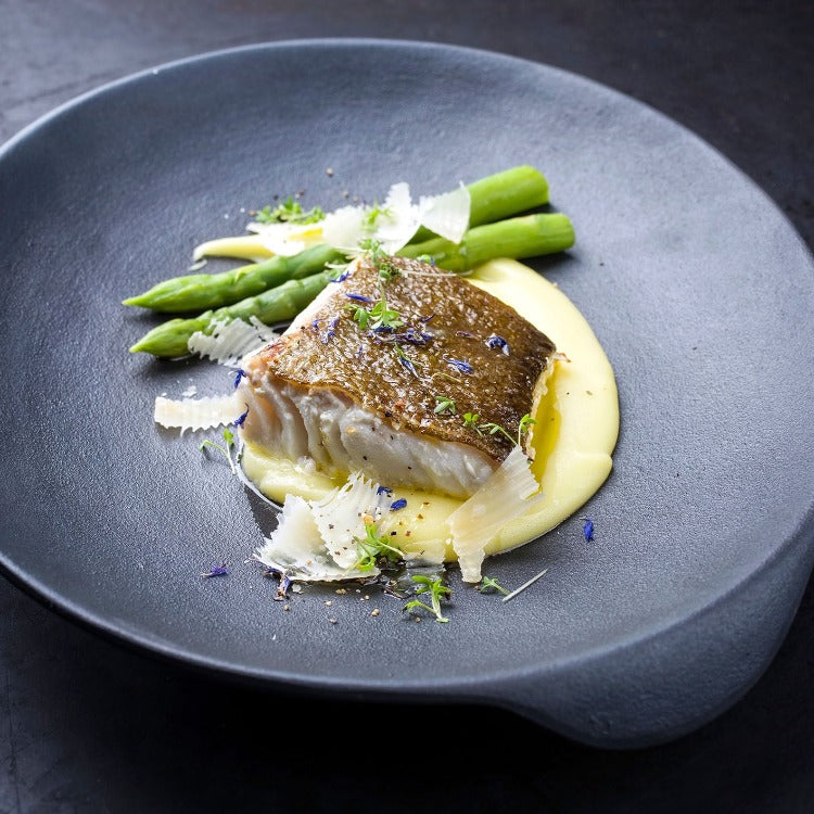 Pan-seared sablefish fillet served with asparagus and a creamy potato puree