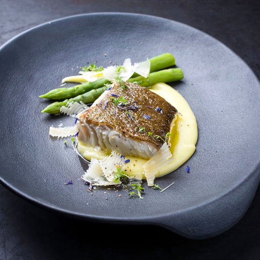 Pan-seared sablefish fillet served with asparagus and a creamy potato puree