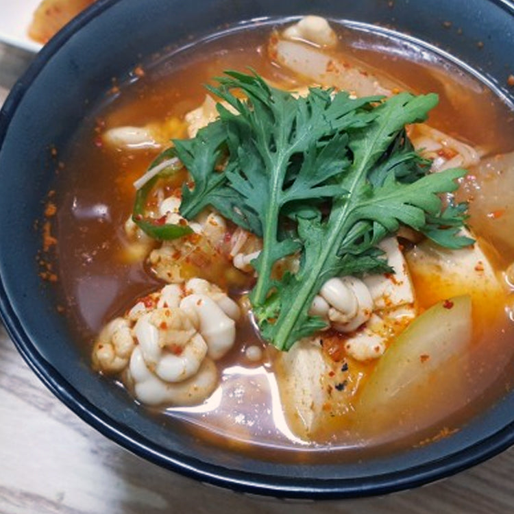 Delicious Cod Milt Soup with Vegetables and Tofu - Traditional Seafood Dish Garnished with Fresh Greens