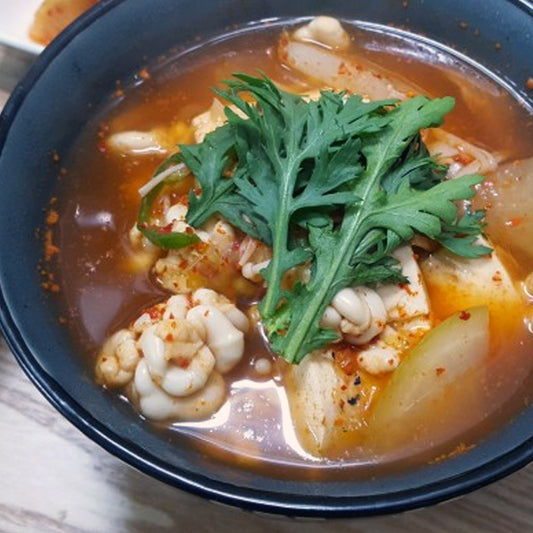 Delicious Cod Milt Soup with Vegetables and Tofu - Traditional Seafood Dish Garnished with Fresh Greens