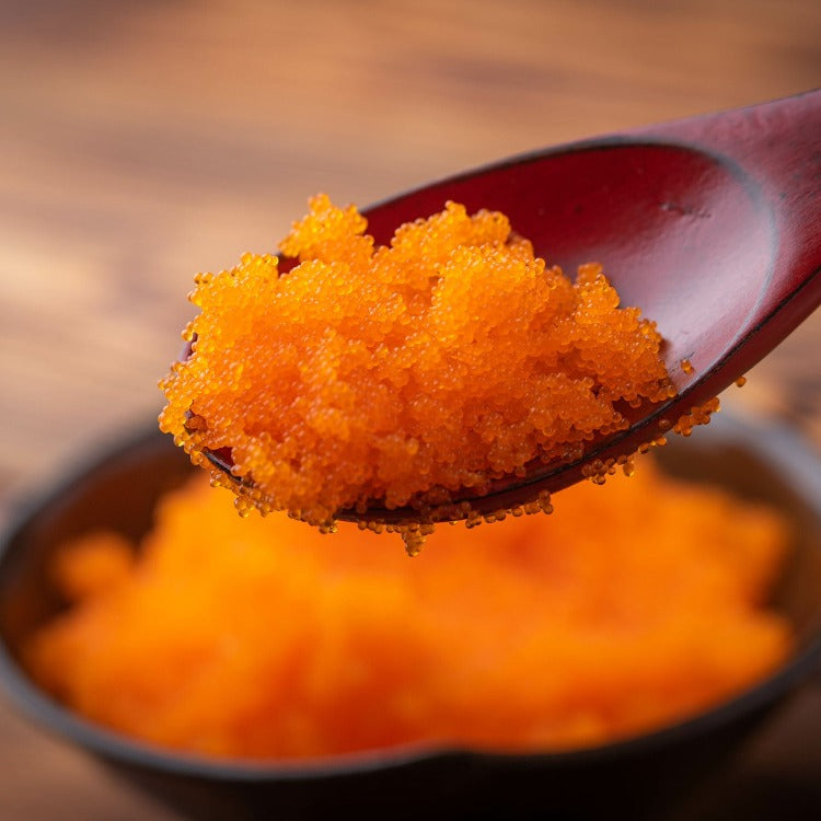 Close-up of orange capelin roe on a spoon