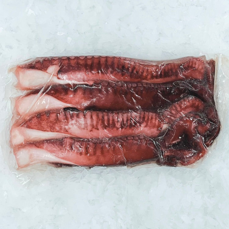 Vacuum-sealed package of fresh tako legs, presented on crushed ice for preserved freshness.