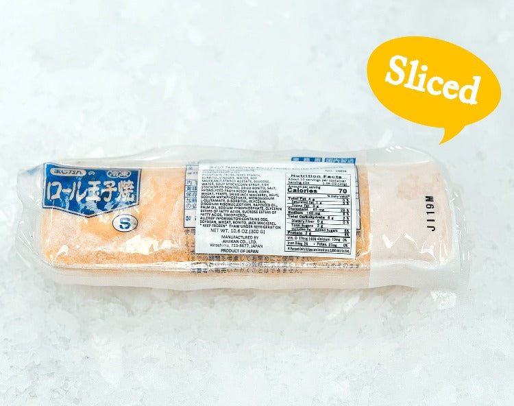 A package of pre-sliced tamagoyaki resting on crushed ice, showcasing its pale yellow color. The packaging features a label with the product name in Japanese and a blue logo, alongside nutritional information clearly displayed, indicating that the product is ready to serve