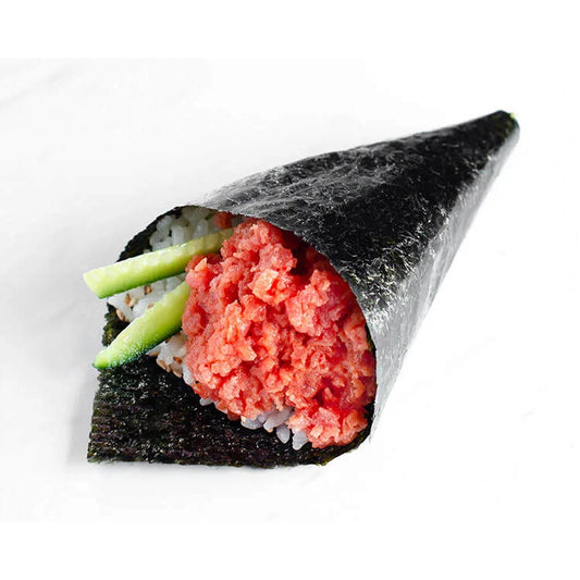 A temaki sushi (hand roll) holding ground yellowfin tuna mixed with green cucumber sticks. The roll is wrapped in a crisp sheet of nori, presenting a casual yet delicious sushi option with fresh, minced tuna as the star ingredient