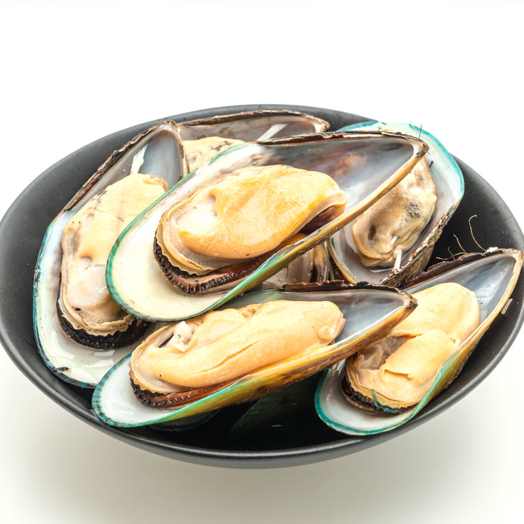A bowl of fresh, steam-cooked half-shell mussels, open and ready to be enjoyed, showcasing their natural juices and delicate texture