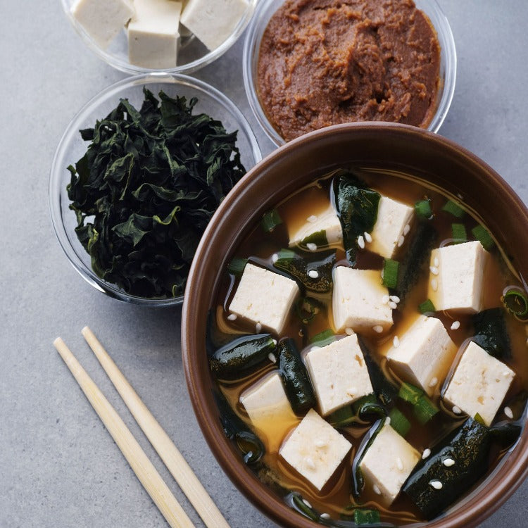 A bowl of tofu, greens, and other ingredients, creating a healthy and delicious meal option