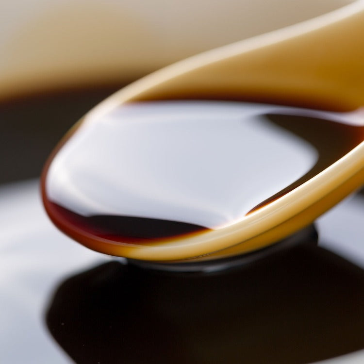 Close-up of a spoonful of Yamasa Usukuchi Light Soy Sauce. Smooth texture and delicate flavor, perfect for seasoning and dipping
