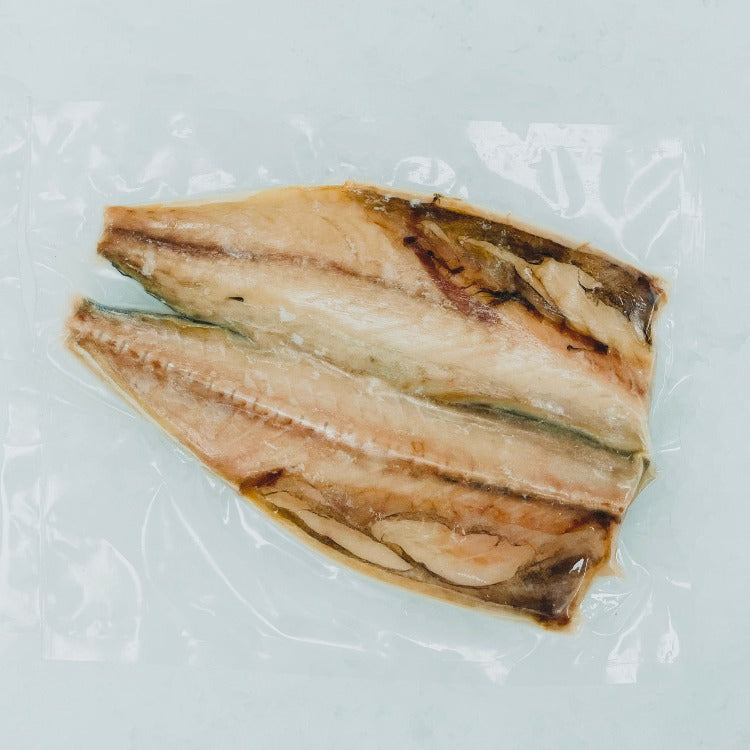 Vacuum-sealed seasoned mackerel fillets, ready to cook, presented on crushed ice to maintain freshness. Perfect for quick and healthy seafood meals