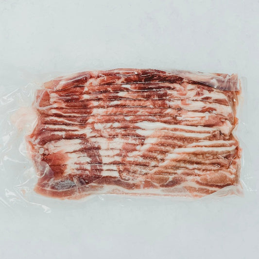 Vacuum-sealed package of fresh pork belly slices, uniformly cut and displayed on crushed ice to preserve freshness. Perfect for culinary uses in both Western and Asian dishes