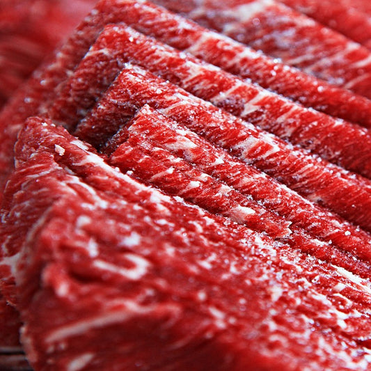 Detailed view of finely sliced beef ribeye, emphasizing the marbling and tenderness. Perfect for hotpot and sukiyaki dishes
