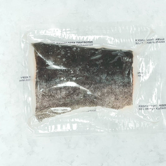 Frozen portion cut sablefish fillet with skin-on, vacuum-sealed for quality